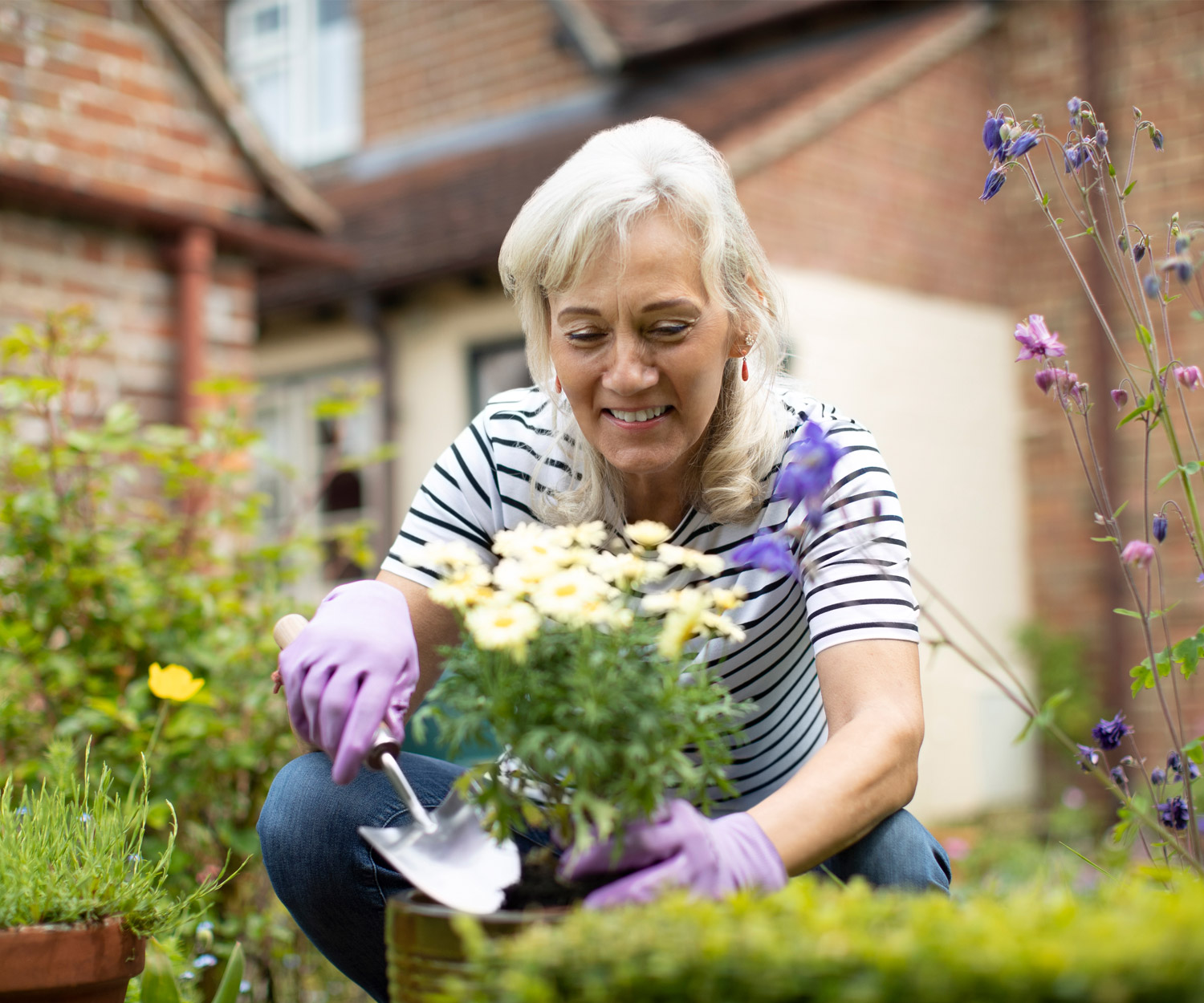 A Woman Tending to a Potted Flower | Virginia Reverse Mortgage